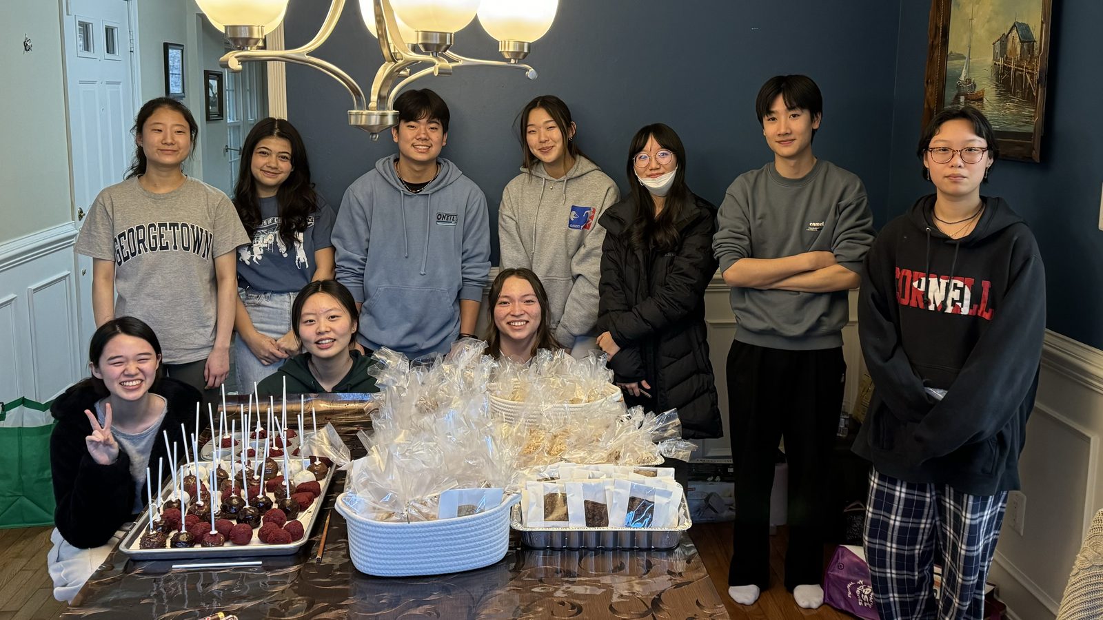 The BTST team behind tables of baked goods on bake sale prep day, February 2024